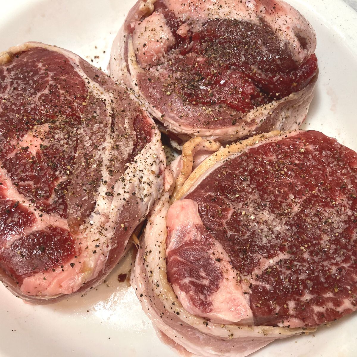 Process shot uncooked filet mignon wrapped in bacon